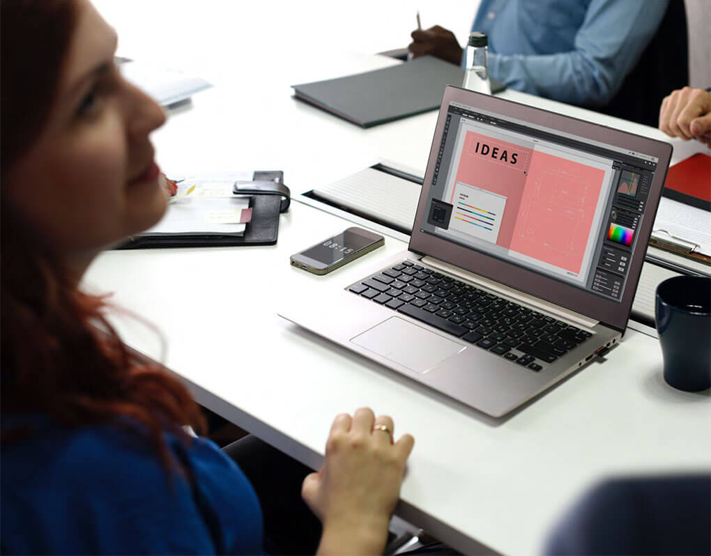Woman With Computer At Meeting